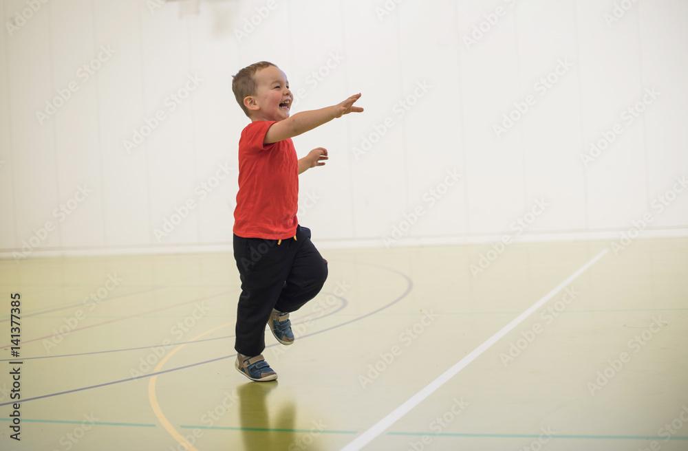 little smiling boy running in gymnasium little smiling boy running in gymnasium