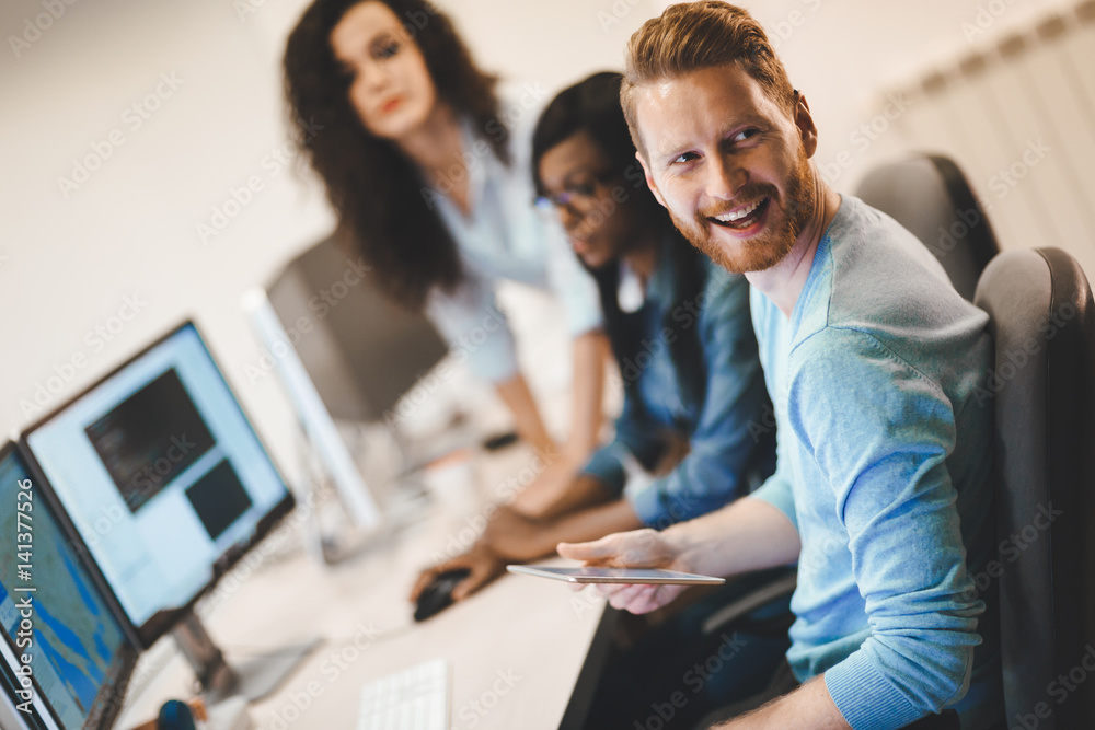 Programmers cooperating at information technology company Programmers cooperating at information technology company