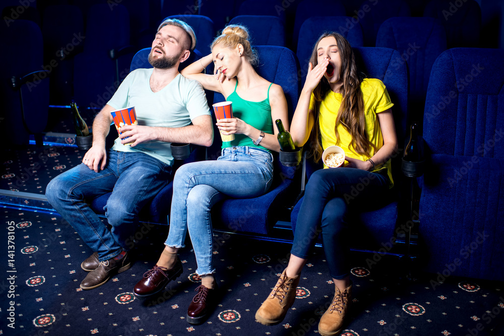 Naklejka premium Friends sleeping during boring film in the cinema