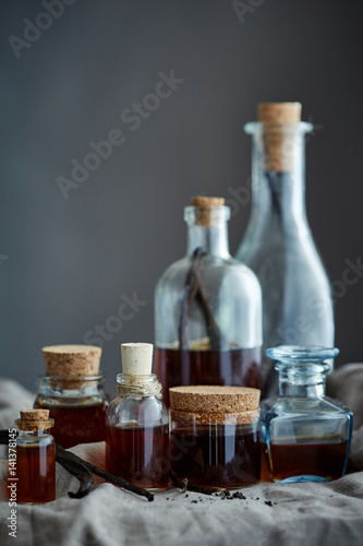 a group of bottles with home made vanilla extract