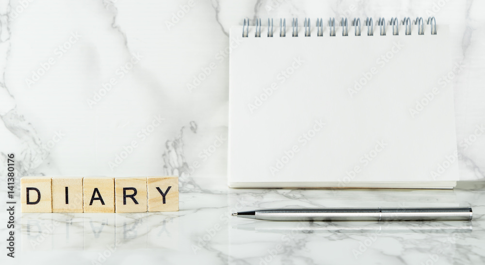 Fotografie Blank notebook dairy on marble sureface with copy space