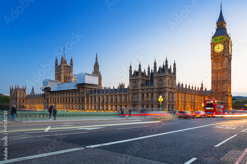 London scenery at Westminster bridge with Big Ben and blurred red bus, UK