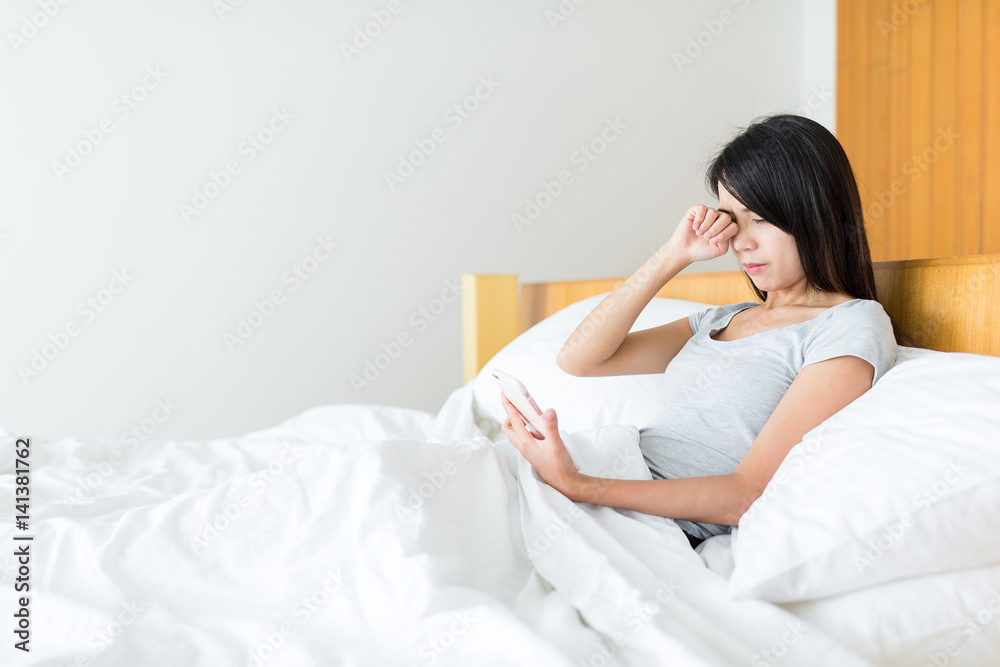 Woman feeling tired for looking at mobile phone Woman feeling tired for looking at mobile phone