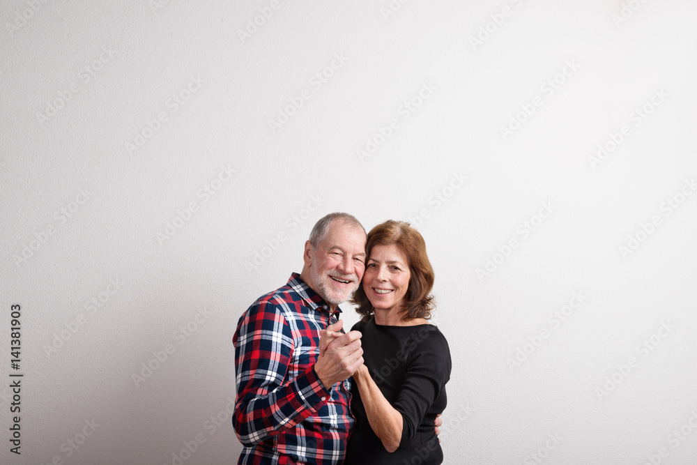 Beautiful senior couple in love dancing. Studio shot. Beautiful senior couple in love dancing. Studio shot.