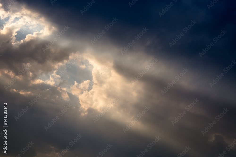 A ray of sunlight breaking through dark clouds. A ray of sunlight breaking through dark clouds.