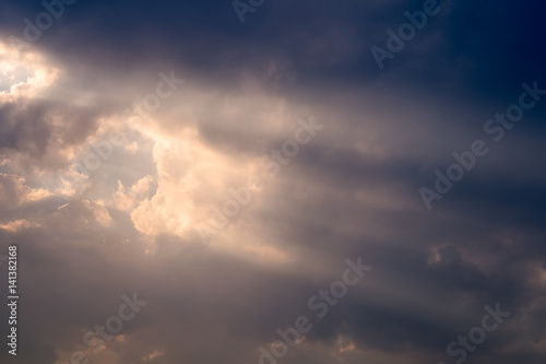 A ray of sunlight breaking through dark clouds.