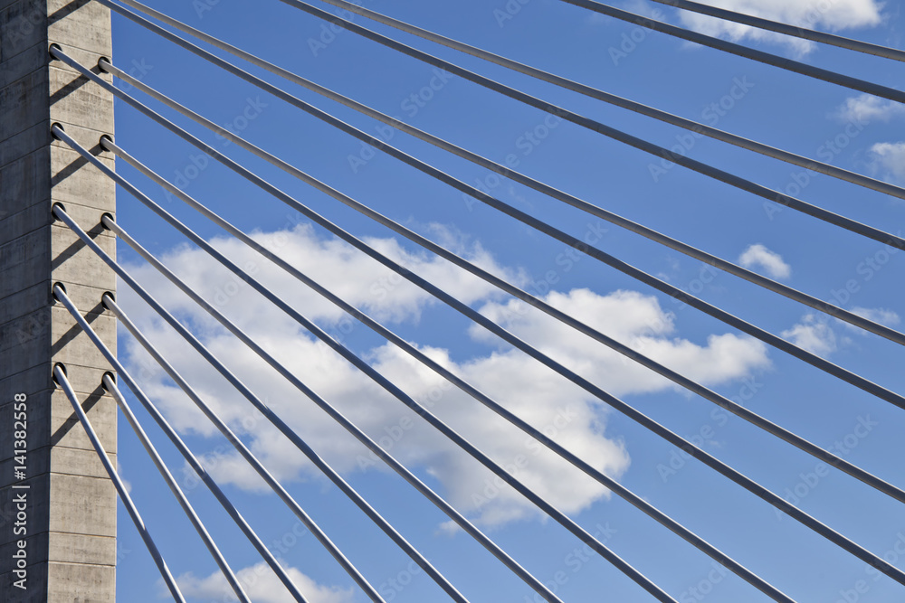 Close up of bridge support cables in front of a cloudy blue sky. Interesting angle shows a unique view. Close up of bridge support cables in front of a cloudy blue sky. Interesting angle shows a unique view.