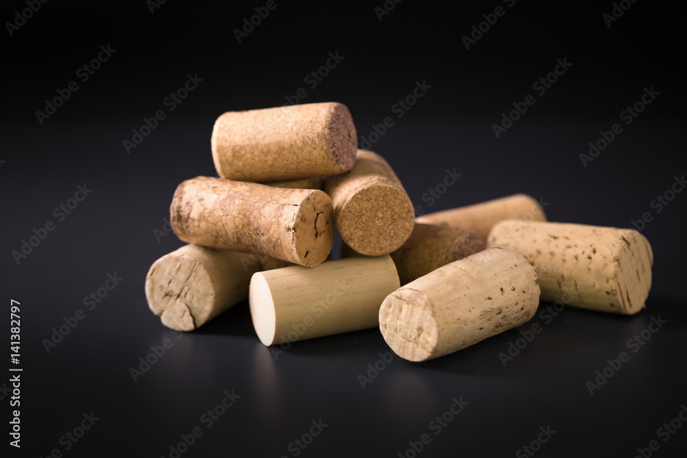 Many wine corks on a dark background