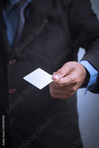 businessman holding a credit card