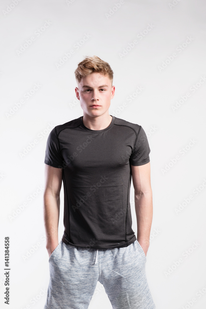 Handsome fitness man in black t-shirt and shorts, studio shot. Handsome fitness man in black t-shirt and shorts, studio shot.