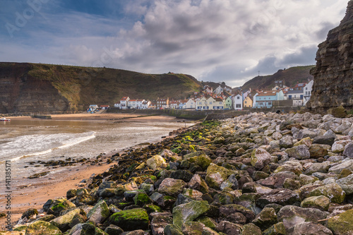 Rocks in Staithes Harbour / Staithes is a pretty seaside village and fishing port on the North Yorkshire coastline, and is today an attractive tourist destination photo