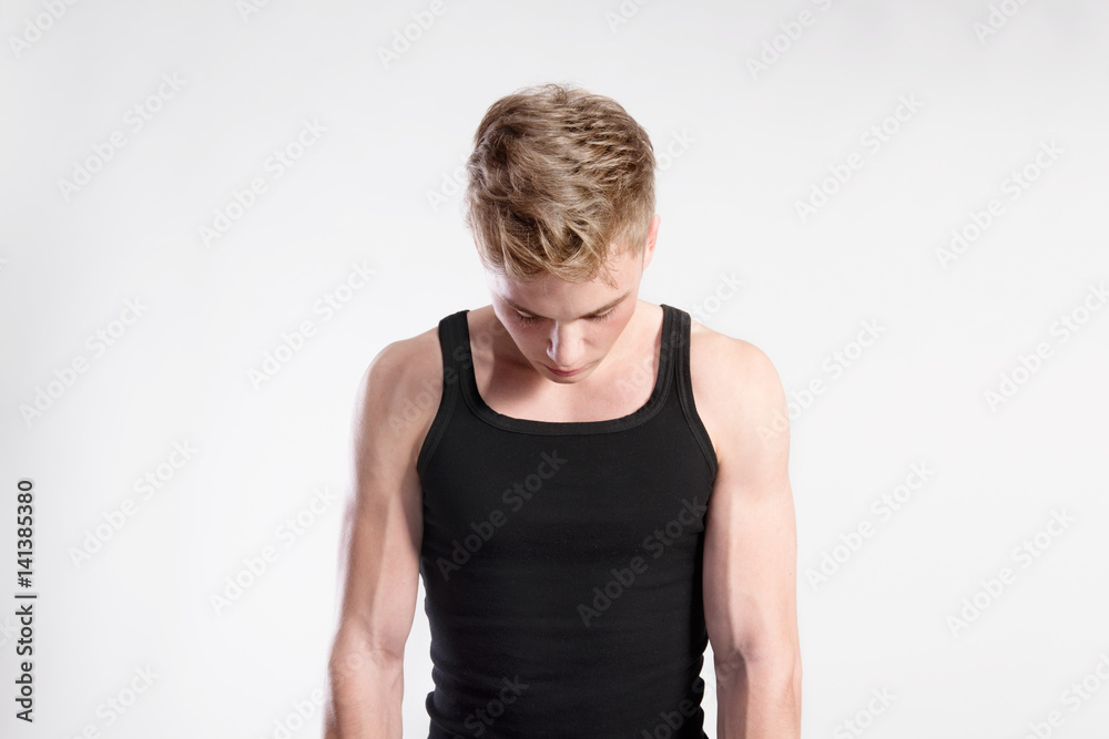 Handsome fitness man in black tank top shirt, studio shot. Handsome fitness man in black tank top shirt, studio shot.