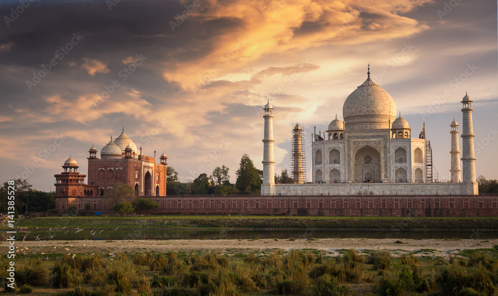 Taj Mahal Agra at sunset as seen from Mehtab Bagh on the banks of the river Yamuna. Taj Mahal designated as a World Heritage Site is a masterpiece of Indian heritage and architecture.