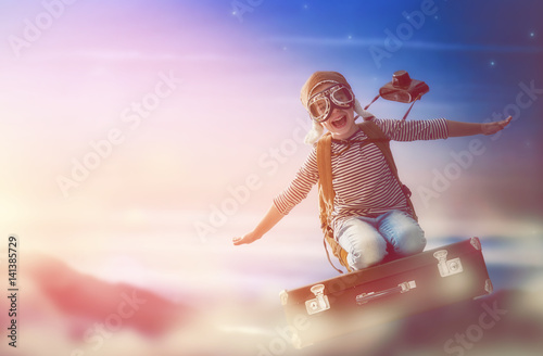 Child flying on a suitcase