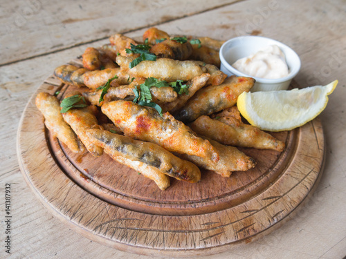 Whitebait deep fried on a wooden platter