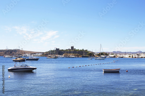 Luxury yachts, sailing and fishing boats in Bodrum bay. Famous landmark castle, was built from 1402 onwards, by the Knights of St John as the Castle of St. Peter or Petronium, is in the background.