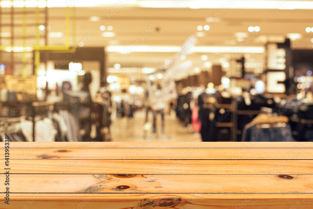 Wooden board empty table blurred background. Perspective brown wood table over blur in department store background - can be used for display or montage your products. Mock up for display of product. Wooden board empty table blurred background. Perspective brown wood table over blur in department store background - can be used for display or montage your products. Mock up for display of product.
