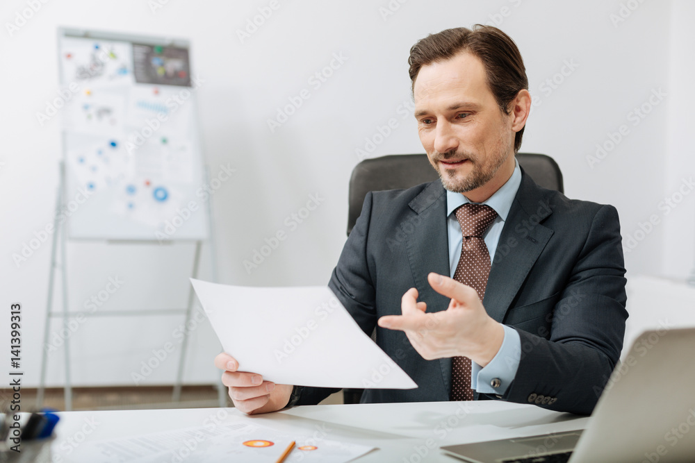 Delighted executive becoming familiar with documents in the office Delighted executive becoming familiar with documents in the office