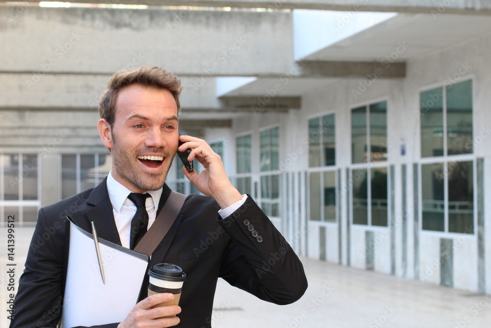 Businessman receiving encouraging news on the phone Businessman receiving encouraging news on the phone