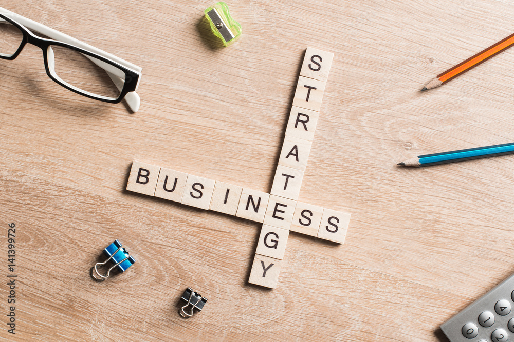 Conceptual business keywords on table with elements of game making crossword Conceptual business keywords on table with elements of game making crossword