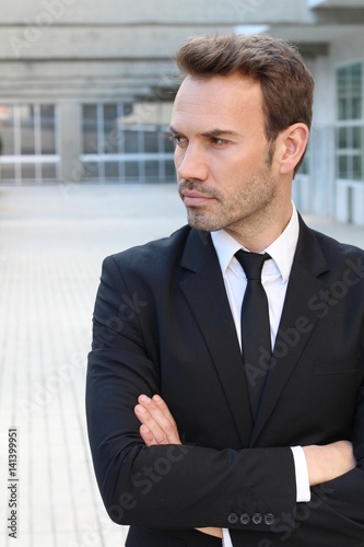 Profile of confident businessman with arms crossed looking away 