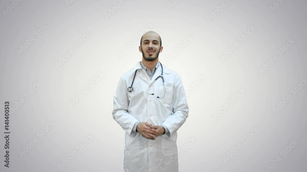 Smiling doctor talking to the camera on white background. Smiling doctor talking to the camera on white background.