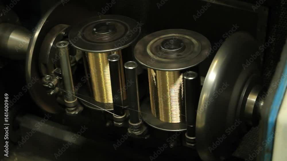 Copper coils spinning. Industrial wire production line. Close up of