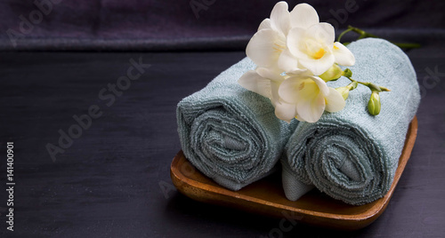 Spa relaxing setting with towels and flowers