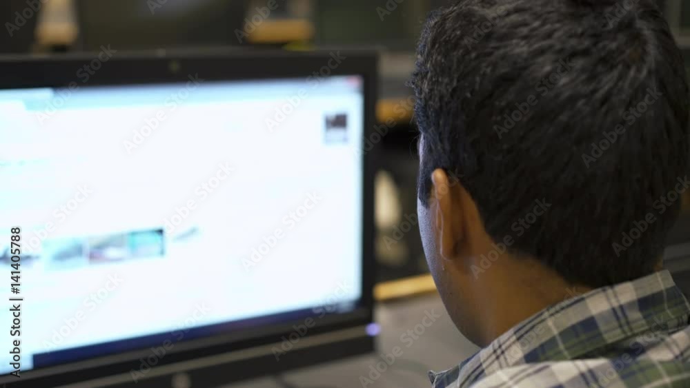 College student using computer on campus at lab.
College student using computer on campus at lab.