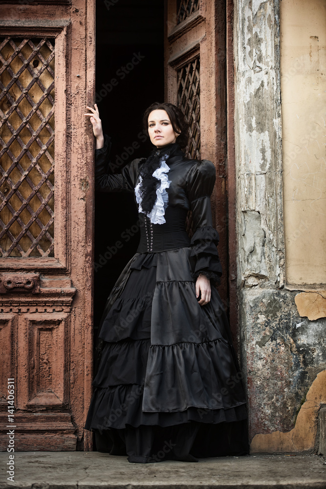 Lady in black standing in the doorway