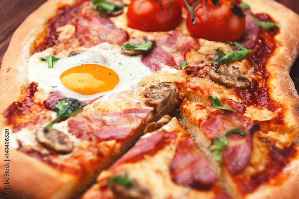 Fresh delicious pizza from the oven with egg, prosciutto and tomato Fresh delicious pizza from the oven with egg, prosciutto and tomato