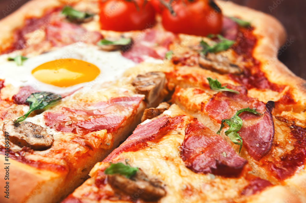 Fresh delicious pizza from the oven with egg, prosciutto and tomato Fresh delicious pizza from the oven with egg, prosciutto and tomato