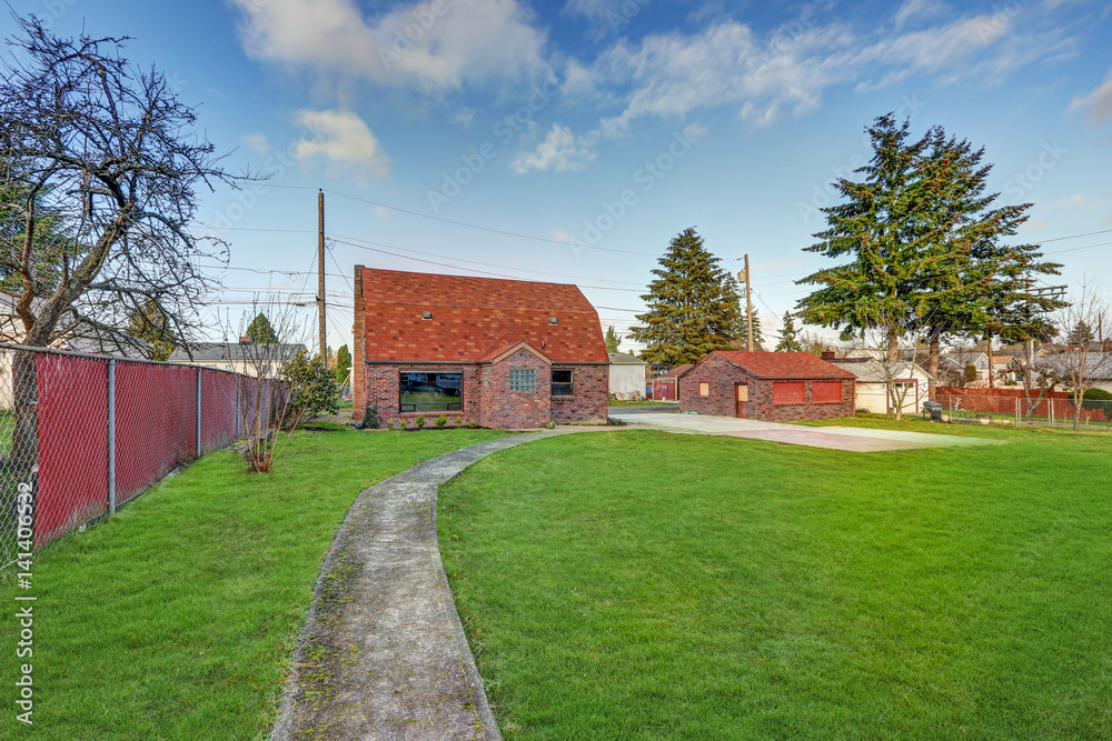 Small red brick home on a sunny day Small red brick home on a sunny day