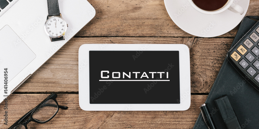 Contatti, Italian text for Contacts on screen of tablet computer at office desk