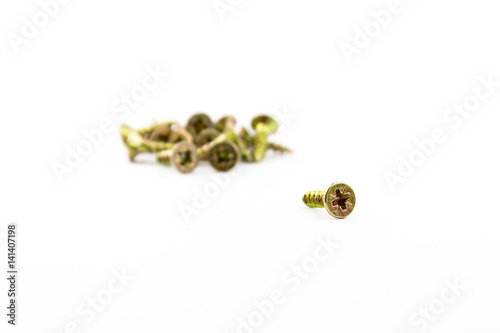 Closeup yellow zinc coated screw isolate on white background. Self Drilling screws. Isolated fasteners. Connecting material on white background. Silver and gold threads on bolts.