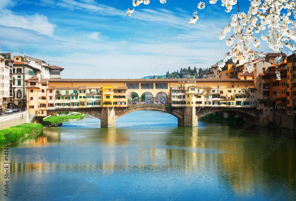 famous bridge Ponte Vecchio over waters of river Arno, Florence at spring day, Italy