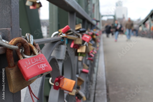 Love locks on a bridge. Close-up of a red lock.