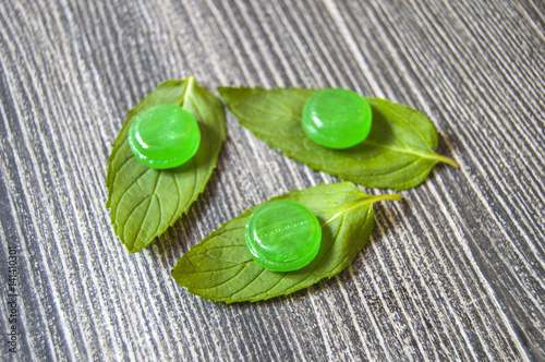 Mint sugar, mint-flavored tiny candies, mint-flavored sugar for cooling, minted sugar for nausea, green mint and mint-flavored sugar concepts 