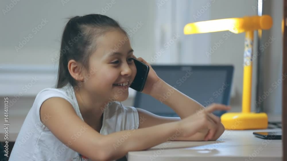 The little girl communicates by phone The little girl communicates by phone