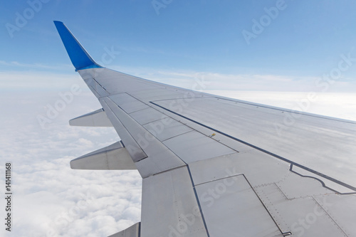 wing of aircraft above clouds