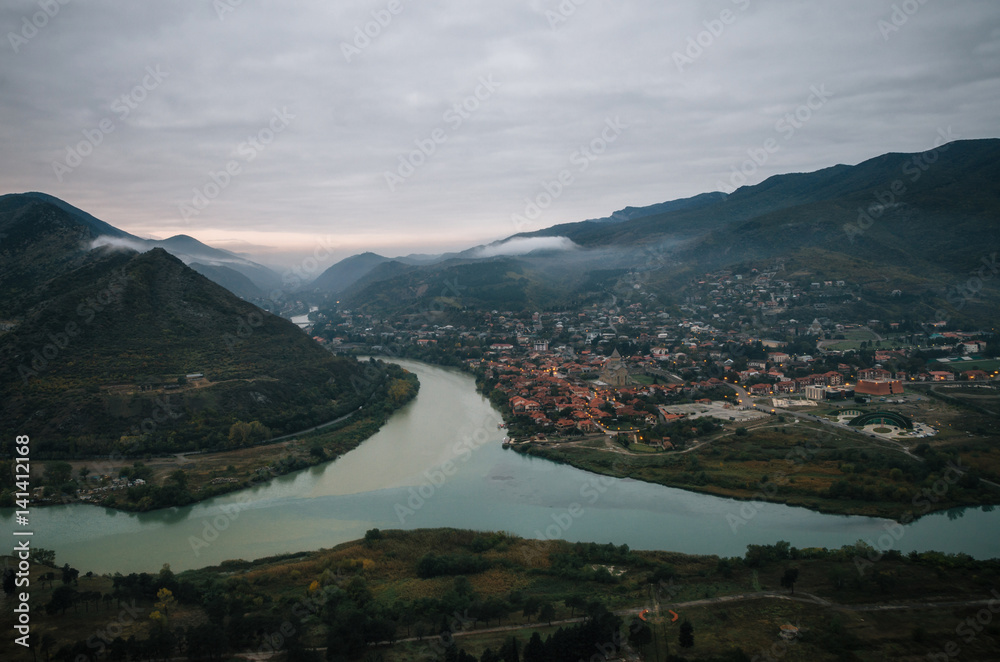 Aerial view of the old georgian capital town Mtskheta with confluence of the Aragvi and Kura at the morning. Landmark of landscape of Georgia