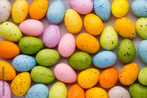 Small multicolored Easter eggs. Spring background.
