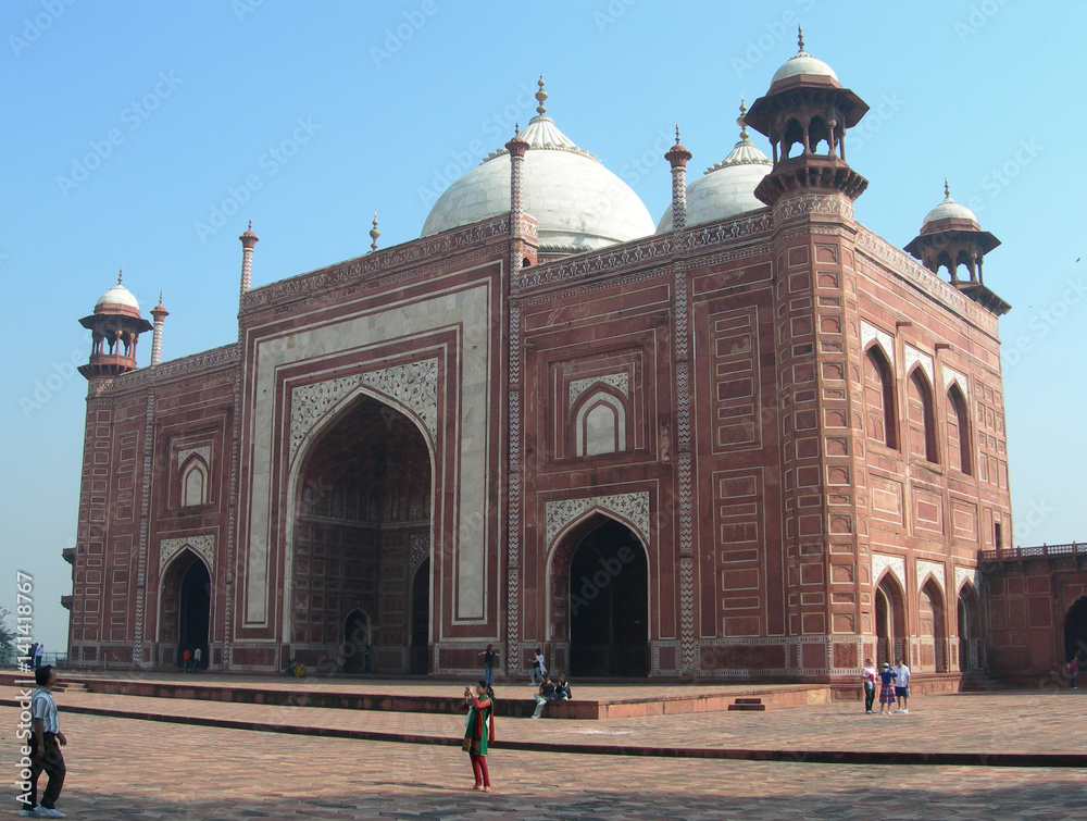 Red sandstone arches mosque near the Taj Mahal mausoleum complex in Agra, India