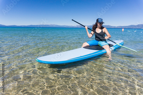 Young woman in hat and sunglasses enjoys watersports on a summer day at Lake Tahoe, California © Jeremy Francis