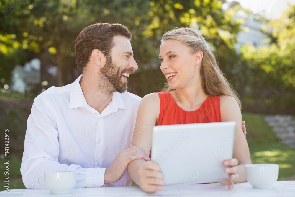 Couple laughing while looking at each other Couple laughing while looking at each other