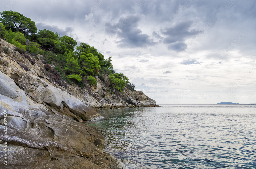 Gorgeous scenery by the sea under a cloudy sky in Sithonia, Chalkidiki, Greece Gorgeous scenery by the sea under a cloudy sky in Sithonia, Chalkidiki, Greece