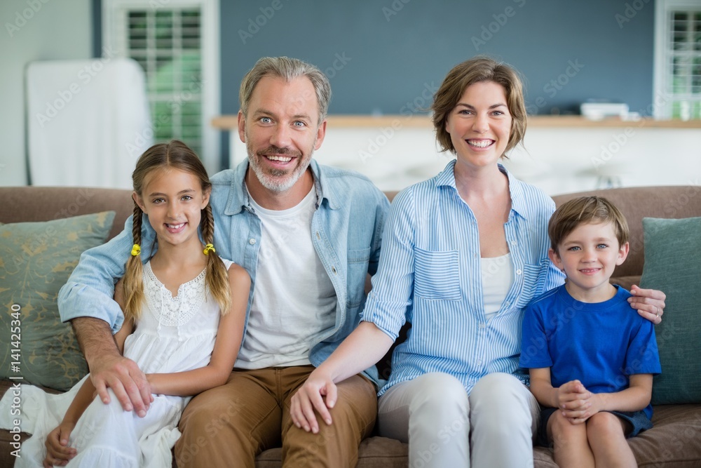 Portrait of smiling family sitting together on sofa Portrait of smiling family sitting together on sofa