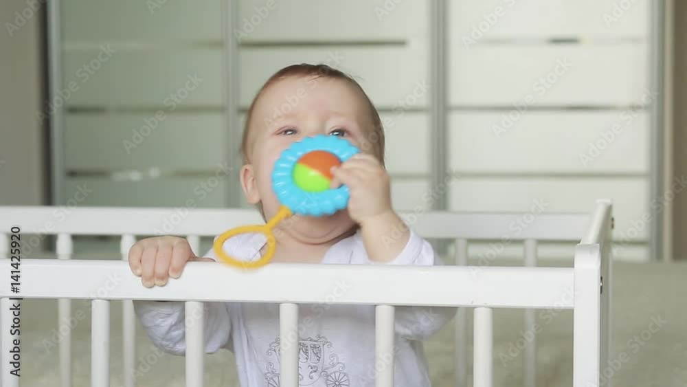 Adorable blonde baby laughing in bed Adorable blonde baby laughing in bed