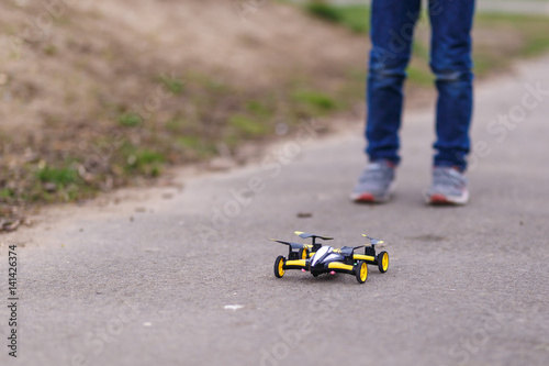 School boy with quadrocopter inthe park photo