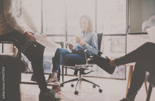 Wallpaper Mural Working process at coworking studio.View of young beautiful woman sitting at the comfortable armchair and using smartphone.Horizontal, blurred background. Torontodigital.ca